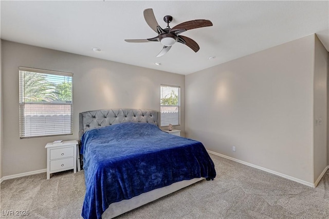 carpeted bedroom featuring baseboards and a ceiling fan