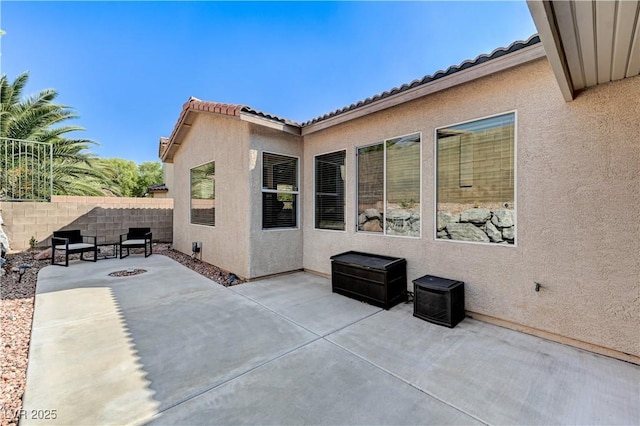 view of patio / terrace featuring fence