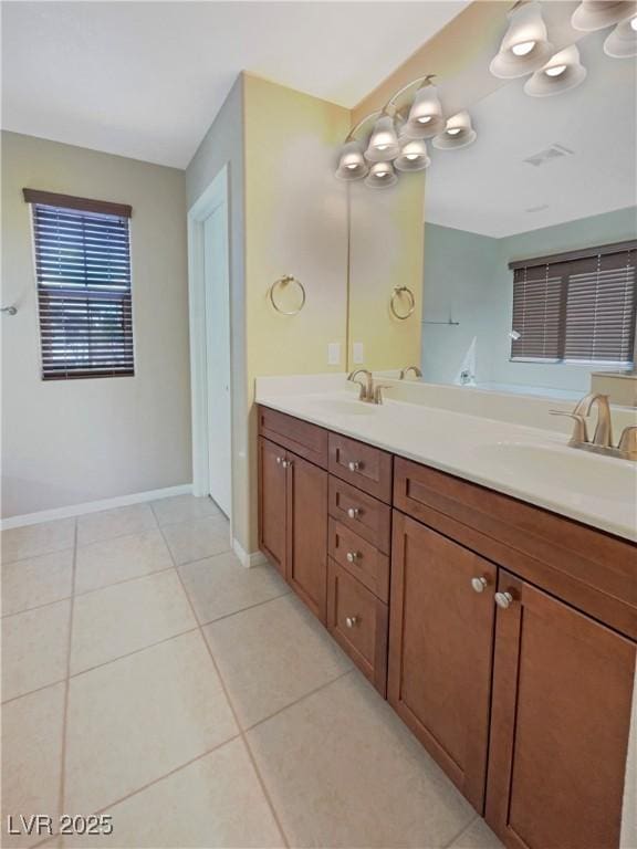 10331 Northern Hills Ave, Las Vegas, NV 89166 - bathroom with a sink, double vanity, baseboards, and tile patterned floors