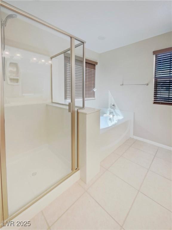 10331 Northern Hills Ave, Las Vegas, NV 89166 - full bathroom with tile patterned floors, baseboards, a shower stall, and a bath