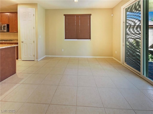 10331 Northern Hills Ave, Las Vegas, NV 89166 - spare room with a wealth of natural light, baseboards, and light tile patterned floors