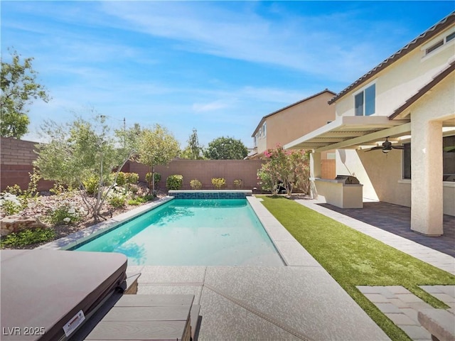 10331 Northern Hills Ave, Las Vegas, NV 89166 - view of swimming pool featuring an outdoor kitchen, a fenced in pool, a patio, ceiling fan, and a fenced backyard