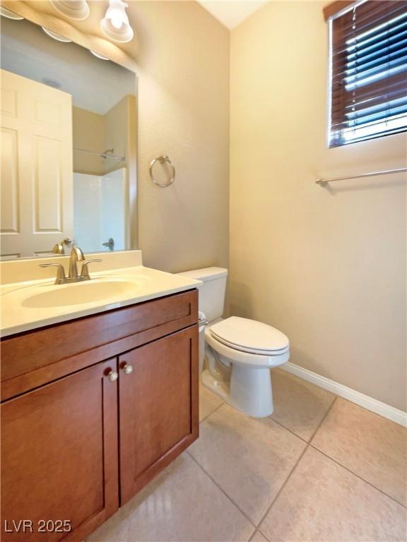 10331 Northern Hills Ave, Las Vegas, NV 89166 - full bathroom with walk in shower, toilet, vanity, tile patterned floors, and baseboards