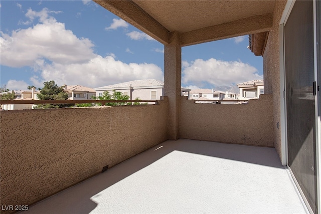 view of patio with a balcony and a residential view