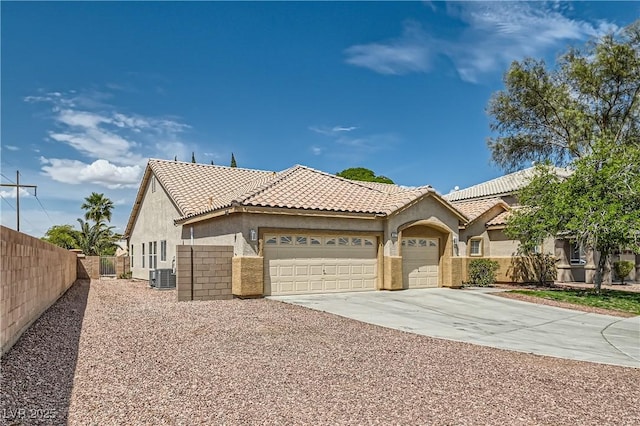427 Rhythm St, Henderson, NV 89074 - view of front of house with driveway, fence, a garage, central air condition unit, and stucco siding