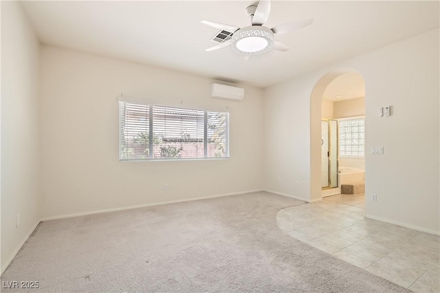 427 Rhythm St, Henderson, NV 89074 - carpeted spare room featuring a wall mounted air conditioner, visible vents, baseboards, ceiling fan, and arched walkways