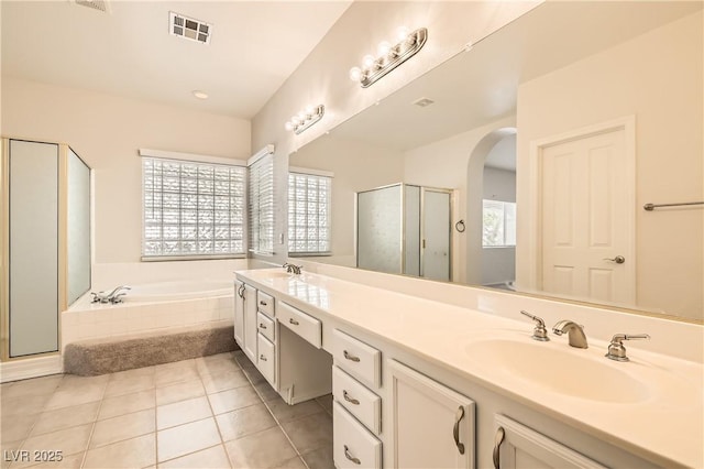 427 Rhythm St, Henderson, NV 89074 - full bathroom with a sink, visible vents, a shower stall, double vanity, and a garden tub