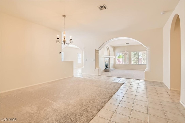 427 Rhythm St, Henderson, NV 89074 - interior space featuring an inviting chandelier, light tile patterned floors, visible vents, arched walkways, and light carpet