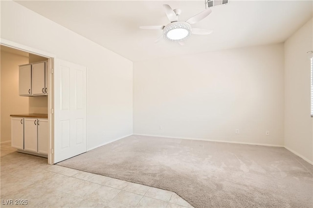 427 Rhythm St, Henderson, NV 89074 - unfurnished room with visible vents, baseboards, ceiling fan, light colored carpet, and light tile patterned flooring