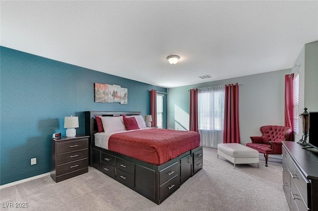 bedroom with light colored carpet, baseboards, and visible vents