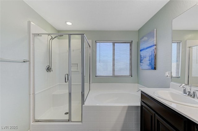 full bath featuring a stall shower, vanity, and a bath
