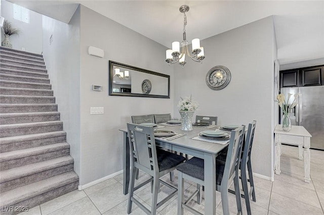 dining space with light tile patterned floors, stairway, an inviting chandelier, and baseboards