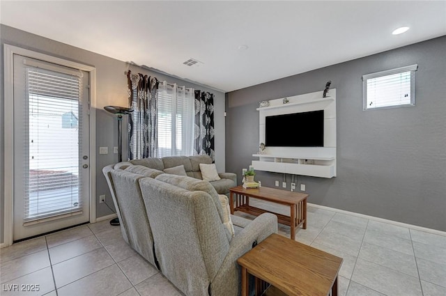living room featuring visible vents, baseboards, and light tile patterned flooring