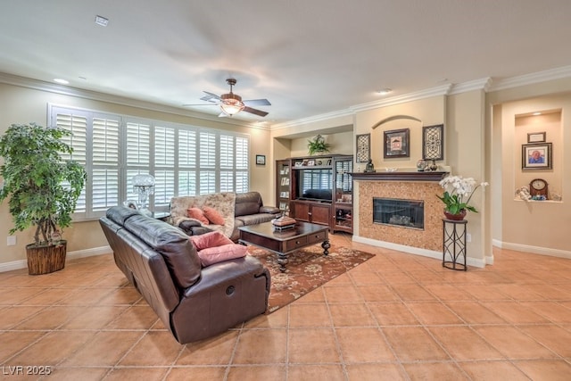 10314 Premia Pl, Las Vegas, NV 89135 - tiled living room featuring baseboards, ceiling fan, a glass covered fireplace, and crown molding