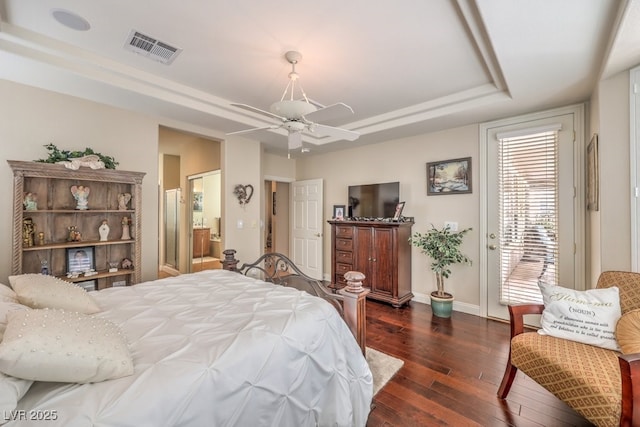 10314 Premia Pl, Las Vegas, NV 89135 - bedroom with visible vents, dark wood finished floors, a tray ceiling, baseboards, and access to exterior