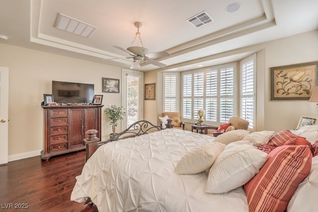 10314 Premia Pl, Las Vegas, NV 89135 - bedroom featuring a tray ceiling, dark wood-type flooring, and visible vents
