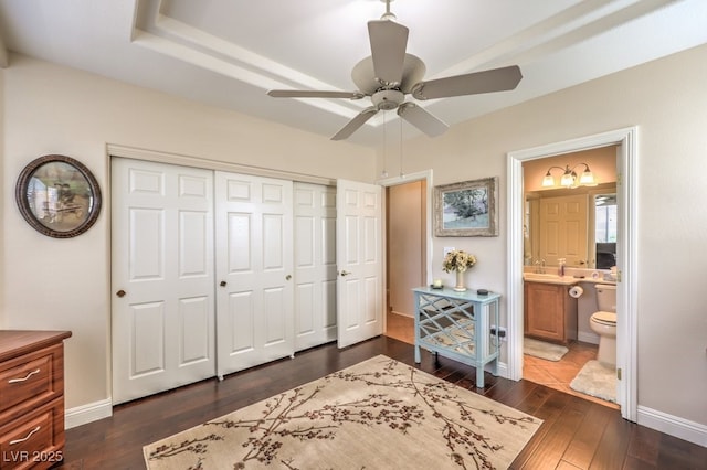 10314 Premia Pl, Las Vegas, NV 89135 - bedroom with a closet, connected bathroom, dark wood-type flooring, and baseboards