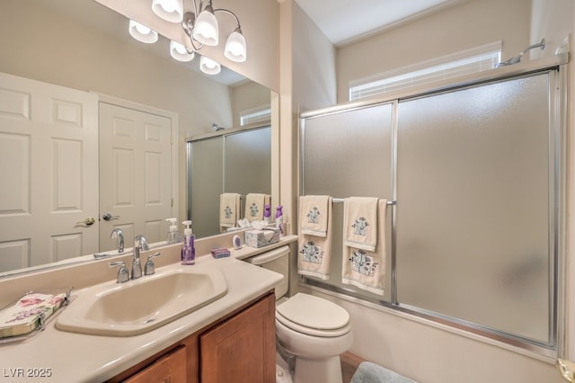 10314 Premia Pl, Las Vegas, NV 89135 - bathroom featuring toilet, vanity, and combined bath / shower with glass door