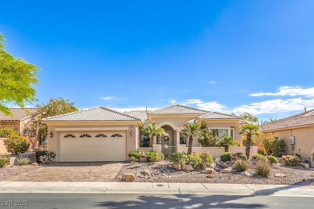 10314 Premia Pl, Las Vegas, NV 89135 - ranch-style house featuring driveway, stucco siding, a tiled roof, and an attached garage