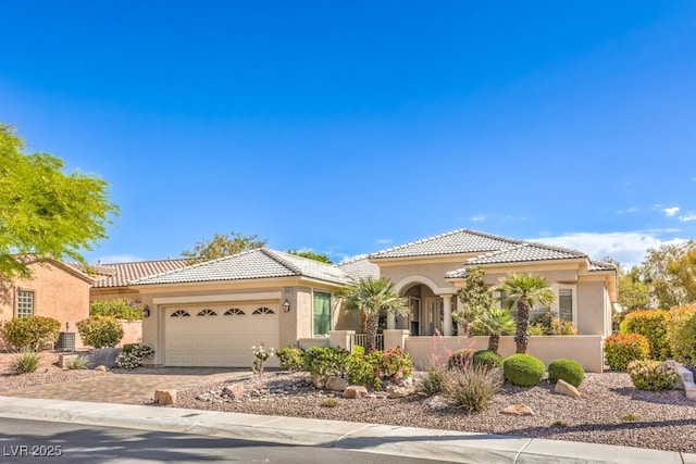 10314 Premia Pl, Las Vegas, NV 89135 - mediterranean / spanish-style house with an attached garage, stucco siding, a tile roof, driveway, and fence private yard