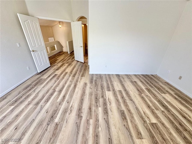 3919 Lilac Haze St, Las Vegas, NV 89147 - unfurnished room featuring light wood finished floors, arched walkways, and baseboards