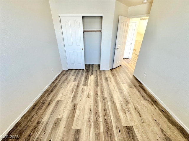 3919 Lilac Haze St, Las Vegas, NV 89147 - unfurnished bedroom with a closet, wood finished floors, and baseboards