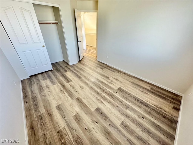 3919 Lilac Haze St, Las Vegas, NV 89147 - unfurnished bedroom featuring baseboards, light wood-style floors, and a closet