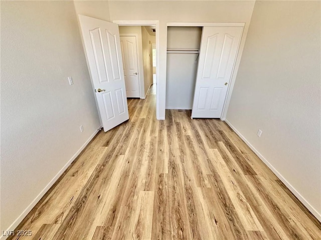 3919 Lilac Haze St, Las Vegas, NV 89147 - unfurnished bedroom featuring baseboards, light wood-style floors, and a closet
