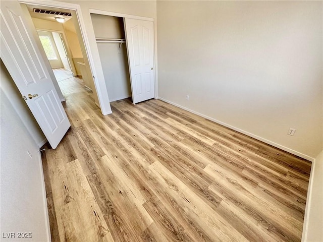 3919 Lilac Haze St, Las Vegas, NV 89147 - unfurnished bedroom with baseboards, a closet, light wood-type flooring, and visible vents