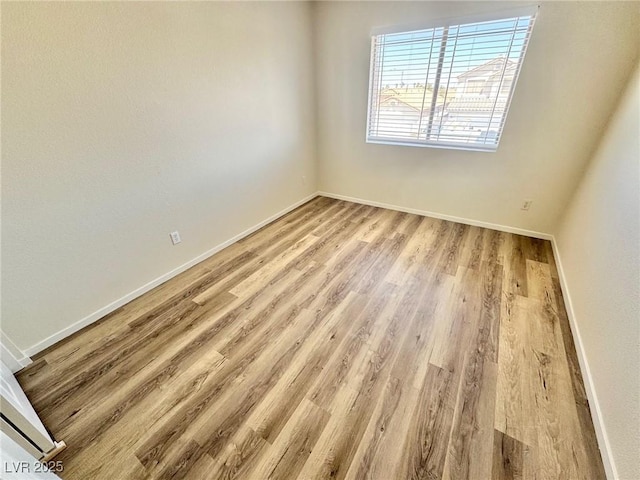 3919 Lilac Haze St, Las Vegas, NV 89147 - spare room with baseboards and wood finished floors
