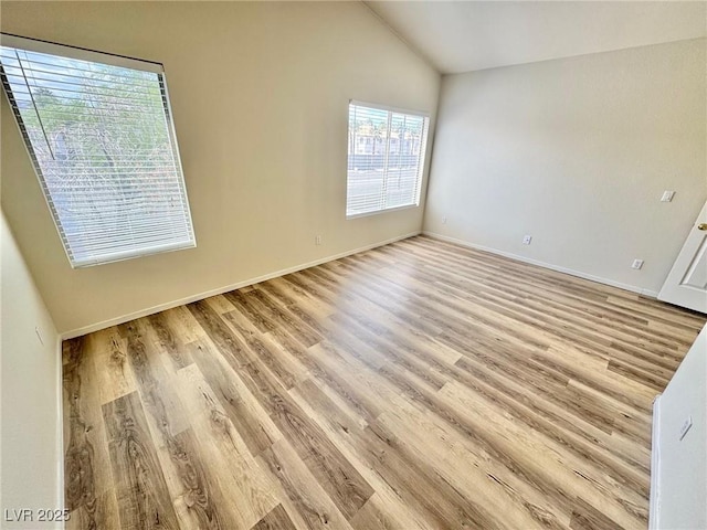 3919 Lilac Haze St, Las Vegas, NV 89147 - unfurnished room featuring light wood-style floors, vaulted ceiling, and baseboards