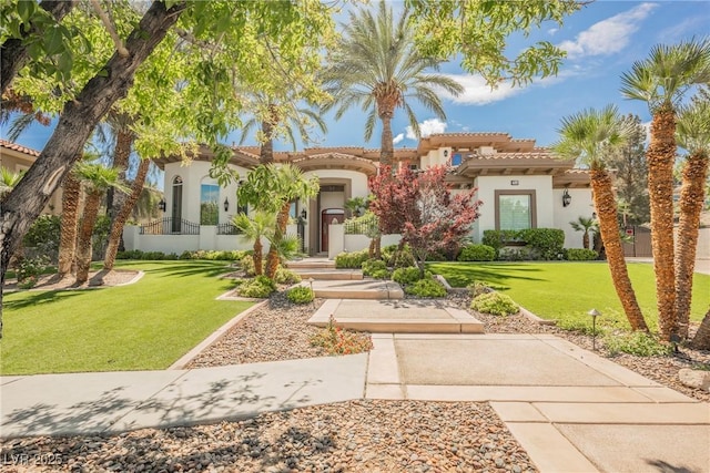 mediterranean / spanish-style house featuring stucco siding, a front yard, and a tile roof