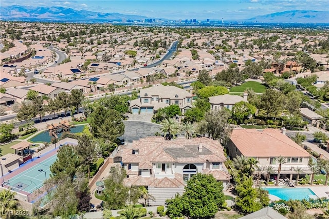 aerial perspective of suburban area with a mountain backdrop and a pool area