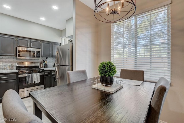 dining space with an inviting chandelier and recessed lighting