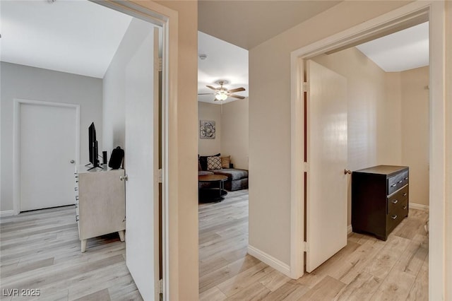 hallway with baseboards and light wood-type flooring