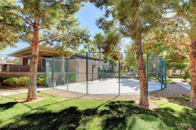 view of basketball court featuring fence