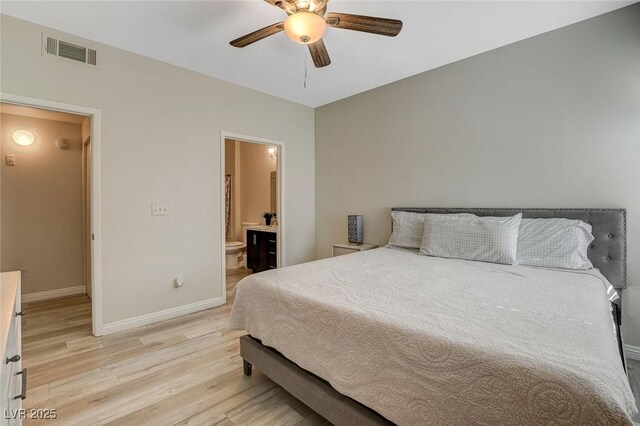 bedroom with light wood-type flooring, visible vents, a ceiling fan, connected bathroom, and baseboards