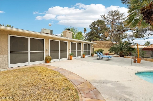 3155 Duneville St, Las Vegas, NV 89146 - back of house featuring a sunroom, a chimney, fence, a patio area, and a fenced in pool