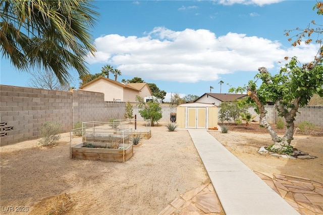 3155 Duneville St, Las Vegas, NV 89146 - view of yard with a vegetable garden, an outbuilding, a fenced backyard, and a storage unit