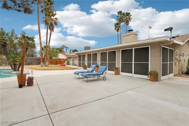 3155 Duneville St, Las Vegas, NV 89146 - back of property featuring a patio area, a chimney, fence, and a fenced in pool