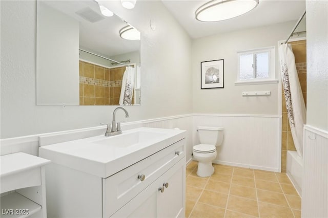 3155 Duneville St, Las Vegas, NV 89146 - full bath featuring toilet, shower / bath combo with shower curtain, tile patterned flooring, wainscoting, and vanity