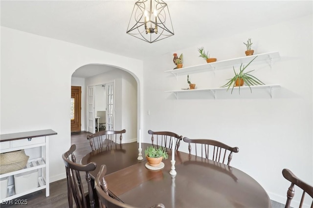 3155 Duneville St, Las Vegas, NV 89146 - dining room with wood finished floors, baseboards, and arched walkways