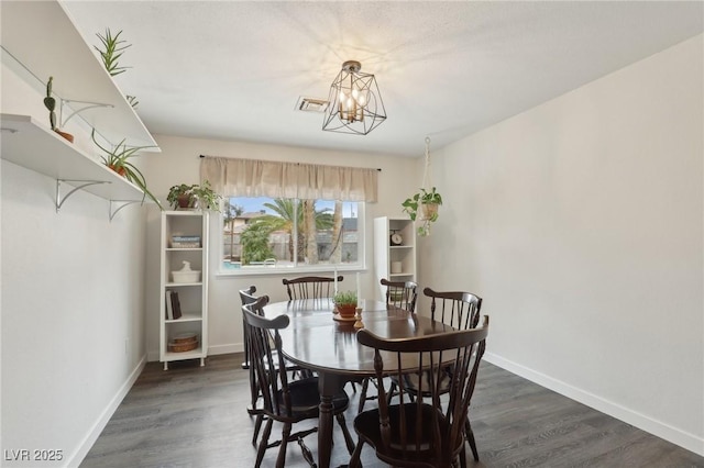 3155 Duneville St, Las Vegas, NV 89146 - dining room with visible vents, baseboards, dark wood-type flooring, and a notable chandelier