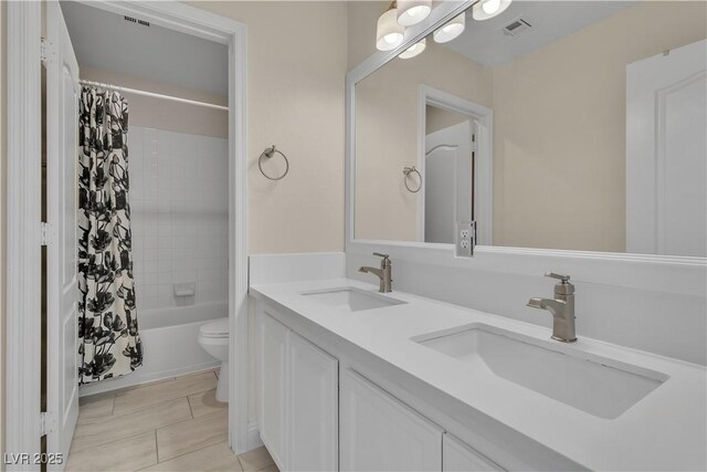 1717 Double Arch Ct, Las Vegas, NV 89128 - full bath featuring toilet, tile patterned flooring, shower / tub combo with curtain, and double vanity