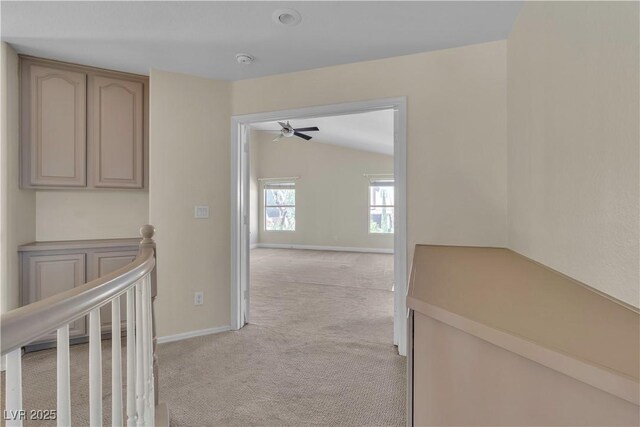 1717 Double Arch Ct, Las Vegas, NV 89128 - hall with an upstairs landing, light carpet, baseboards, and lofted ceiling