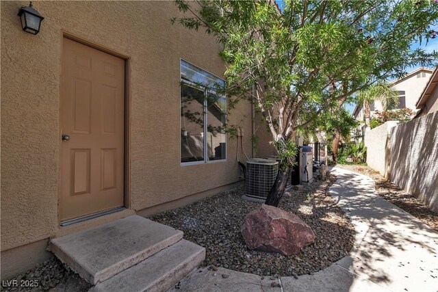 1717 Double Arch Ct, Las Vegas, NV 89128 - property entrance featuring fence, stucco siding, cooling unit, and a patio area