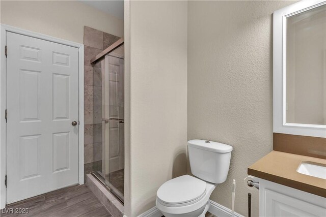 1717 Double Arch Ct, Las Vegas, NV 89128 - full bath featuring toilet, wood finished floors, a shower stall, a textured wall, and vanity
