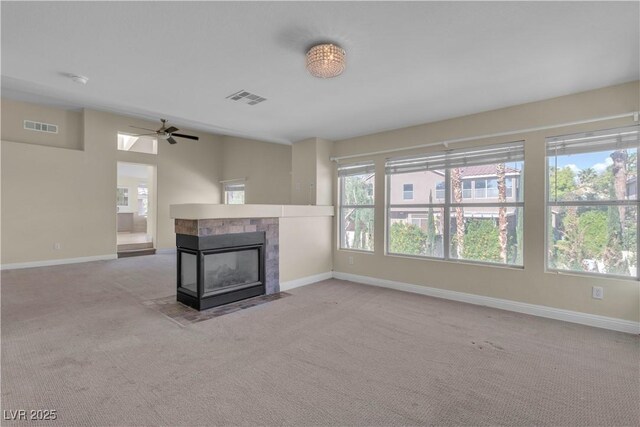 1717 Double Arch Ct, Las Vegas, NV 89128 - unfurnished living room featuring a tiled fireplace, visible vents, and carpet floors