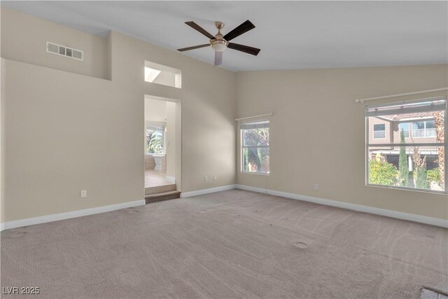 1717 Double Arch Ct, Las Vegas, NV 89128 - spare room with light carpet, a ceiling fan, baseboards, and lofted ceiling