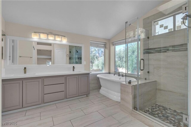 1717 Double Arch Ct, Las Vegas, NV 89128 - bathroom with a sink, a soaking tub, a shower stall, and vaulted ceiling